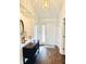Bright foyer featuring hardwood floors, fresh neutral paint, decorative niche, and modern light fixture at 10477 Silver Ridge Cir, Fishers, IN 46038