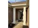 Covered front porch featuring white columns, brick facade, glass door, and modern outdoor lighting at 10477 Silver Ridge Cir, Fishers, IN 46038