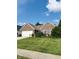 Charming brick home with a well-manicured lawn, flowering shrubs, and a two car garage at 10477 Silver Ridge Cir, Fishers, IN 46038