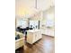 Sunlit kitchen with quartz counters, island seating, modern lighting, and stainless steel appliances at 10477 Silver Ridge Cir, Fishers, IN 46038