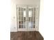 Living room featuring hard wood floors and glass french doors, bringing natural light into the space at 10477 Silver Ridge Cir, Fishers, IN 46038