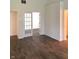 Bright living room featuring dark wood floors, white trim, and access to other rooms through classic paneled doors at 10477 Silver Ridge Cir, Fishers, IN 46038