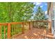 A wooden back deck with lush green trees nearby at 1139 Fernwood Way, Plainfield, IN 46168
