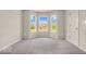 This bedroom has three large windows overlooking the neighborhood and plush carpeted floors at 1139 Fernwood Way, Plainfield, IN 46168