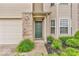 Inviting front entrance with green door, brick accents and manicured landscaping at 1139 Fernwood Way, Plainfield, IN 46168