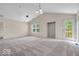 Bright living room featuring neutral walls, vaulted ceilings, and access to outdoor deck at 1139 Fernwood Way, Plainfield, IN 46168