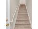 Carpeted staircase with white railing leading to the upper level of the home at 1139 Fernwood Way, Plainfield, IN 46168