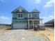 Two-story home with attached garage and green protective wrap at 114 Velvet Hat Rd, Danville, IN 46122