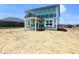 Two-story home with covered porch and green protective wrap at 114 Velvet Hat Rd, Danville, IN 46122