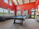 Spacious game room with pool table, shuffleboard, high ceilings, and large windows for entertainment at 114 Velvet Hat Rd, Danville, IN 46122
