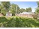 A lush backyard featuring a shed and partially fenced yard with green grass at 1205 Park Dr, Lebanon, IN 46052