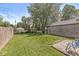 A well-manicured lawn, partial fencing, mature trees, and a stone exterior building at 1205 Park Dr, Lebanon, IN 46052