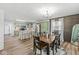 Charming dining area with wood floors, a modern light fixture, and wainscoting at 1205 Park Dr, Lebanon, IN 46052