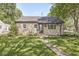 Charming stone home with a well-maintained lawn and walkway leading to the front door at 1205 Park Dr, Lebanon, IN 46052