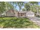 A beautiful ranch home featuring a stone exterior, attached garage, and well-manicured front lawn at 1205 Park Dr, Lebanon, IN 46052