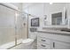 Bright bathroom featuring glass enclosed shower, sleek vanity with modern fixtures, and picture frame at 12078 Black Mill Pass, Fishers, IN 46040
