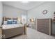 Bright bedroom featuring a comfortable bed, study space, and a spacious closet at 12078 Black Mill Pass, Fishers, IN 46040