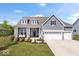Charming two-story home with gray siding, white trim, and a covered front porch with a swing at 12078 Black Mill Pass, Fishers, IN 46040