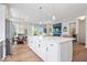 Open-concept kitchen with a large island, stainless steel appliances, and hardwood floors at 12078 Black Mill Pass, Fishers, IN 46040