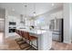 Modern kitchen with white cabinets, stainless steel appliances, and a large island with seating at 12078 Black Mill Pass, Fishers, IN 46040