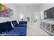 Comfortable living room with a blue sectional sofa, entertainment center, and stylish decor at 12078 Black Mill Pass, Fishers, IN 46040