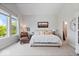 Comfortable main bedroom featuring a large window, seating area, and neutral decor at 12078 Black Mill Pass, Fishers, IN 46040