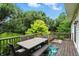 Comfortable back deck with wicker dining furniture and green foliage, perfect for outdoor entertaining at 13020 Lombard Ct, Fishers, IN 46038