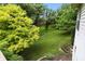 Lush backyard view from the deck with mature trees and verdant green space at 13020 Lombard Ct, Fishers, IN 46038