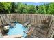 Charming backyard patio with cozy seating, plants and shaded green backdrop at 13020 Lombard Ct, Fishers, IN 46038