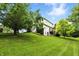 Spacious backyard showcasing a well-maintained lawn and mature trees, providing a private and serene outdoor space at 13020 Lombard Ct, Fishers, IN 46038