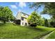 Spacious backyard featuring lush greenery, a gentle slope, and beautiful landscaping at 13020 Lombard Ct, Fishers, IN 46038