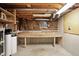 Unfinished basement area featuring a workbench, window, and exposed ceiling at 13020 Lombard Ct, Fishers, IN 46038