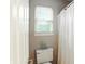 Cozy bathroom with white shower curtain and window at 13020 Lombard Ct, Fishers, IN 46038