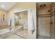 Bright bathroom featuring a tub, toilet and shower with glass door at 13020 Lombard Ct, Fishers, IN 46038