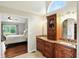 Bright bathroom featuring double vanity with granite countertop and wood cabinets at 13020 Lombard Ct, Fishers, IN 46038