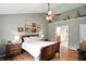Comfortable bedroom features neutral walls, wood floors, and ensuite bath access at 13020 Lombard Ct, Fishers, IN 46038