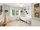 Bright bedroom featuring stylish bed with decorative pillows, artwork and window views at 13020 Lombard Ct, Fishers, IN 46038