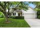 Charming two-story home with a well-manicured lawn and attached two-car garage, creating a welcoming curb appeal at 13020 Lombard Ct, Fishers, IN 46038
