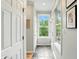 Bright hallway featuring a window with green views and light-colored walls at 13020 Lombard Ct, Fishers, IN 46038