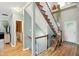Inviting hallway featuring wooden floors and access to staircase at 13020 Lombard Ct, Fishers, IN 46038
