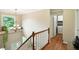 Hallway with wood railing, window, and view of laundry room at 13020 Lombard Ct, Fishers, IN 46038