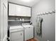 Practical laundry room featuring washer, dryer, and overhead cabinets at 13020 Lombard Ct, Fishers, IN 46038