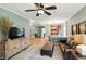 This open-concept living room boasts hardwood floors and is bathed in natural light with views of the kitchen and dining area at 13020 Lombard Ct, Fishers, IN 46038