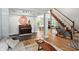 Inviting living room featuring hardwood floors and a view into dining area and staircase at 13020 Lombard Ct, Fishers, IN 46038