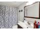 This bathroom has a floral shower curtain, a large mirror above the vanity, and a toilet at 1305 Gumwood Dr, Indianapolis, IN 46234