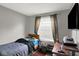 Simple bedroom with grey walls, a small window, and a wooden desk for a student or single occupant at 1305 Gumwood Dr, Indianapolis, IN 46234