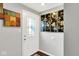 Entryway with a decorative glass front door, gray walls, and artwork, leading into the home at 1305 Gumwood Dr, Indianapolis, IN 46234