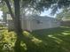 Home featuring neutral vinyl siding, a well-kept lawn, and seamless gutters at 1306 Woodbine Dr, Anderson, IN 46011
