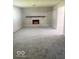 Cozy basement featuring a painted brick fireplace, plush carpeting, and neutral tones at 1306 Woodbine Dr, Anderson, IN 46011