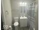 Standard bathroom featuring gray shower curtain, vanity, medicine cabinet and updated fixtures at 1306 Woodbine Dr, Anderson, IN 46011